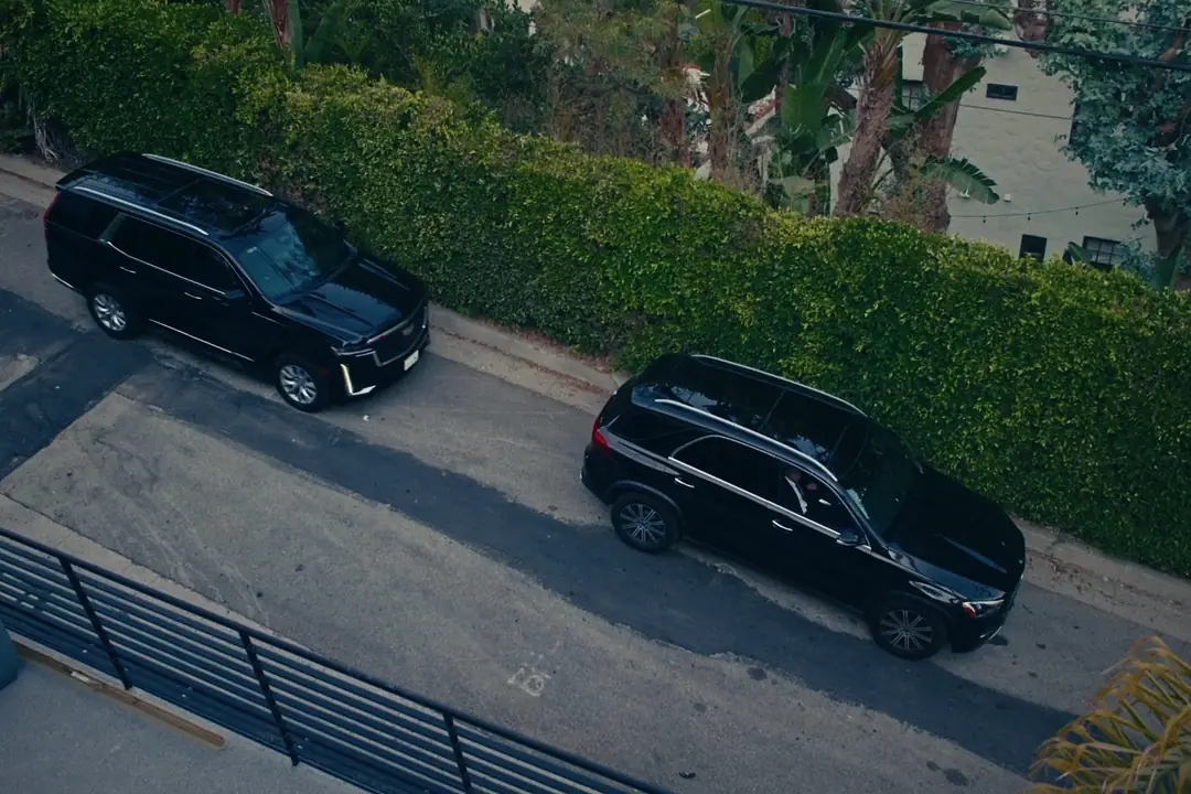 Convoy of black armored SUVs on the road