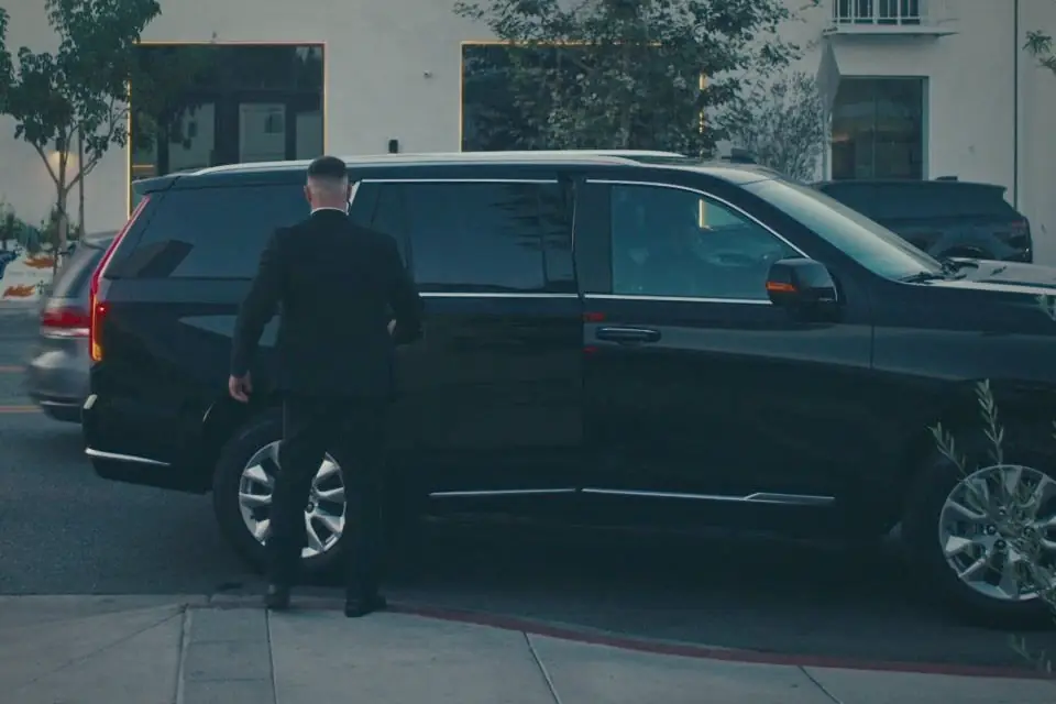 LDG agent opening an SUV door for an arrival at an event