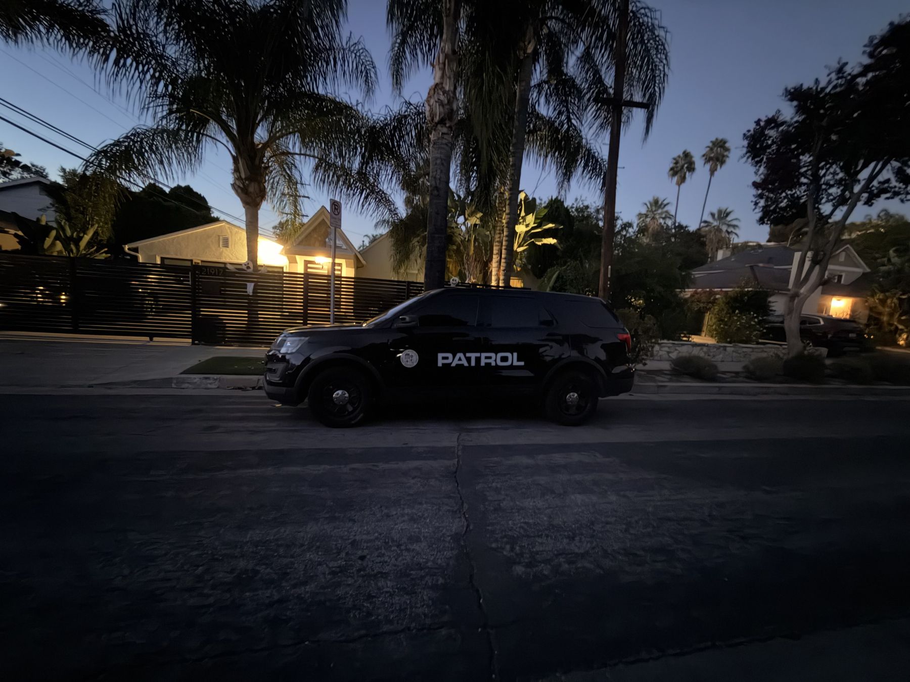 Black LDG patrol vehicle parked on a residential street at dusk